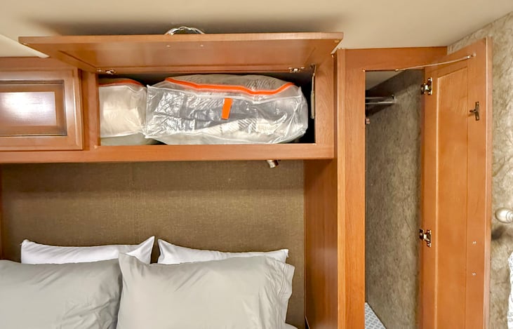 Closet storage. Extra bedding stored overhead.