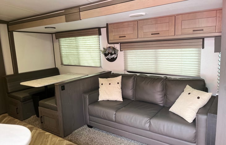 Pull out couch, dining table comfortably seats four and folds down for sleeping area.