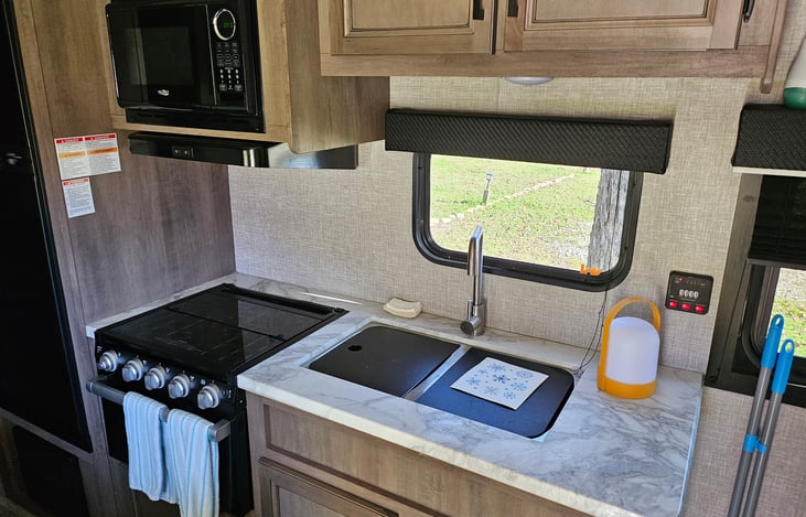 4 burner gas stove and oven, microwave and double sink.