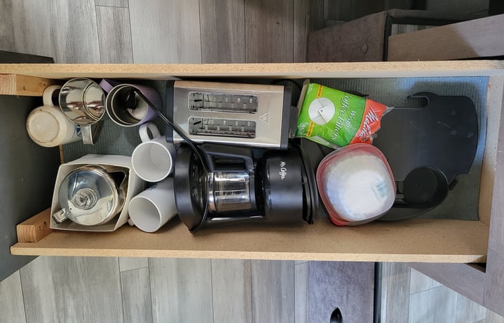 4 cup coffee maker,(electric & percolator)  filters, toaster and several coffee mugs.