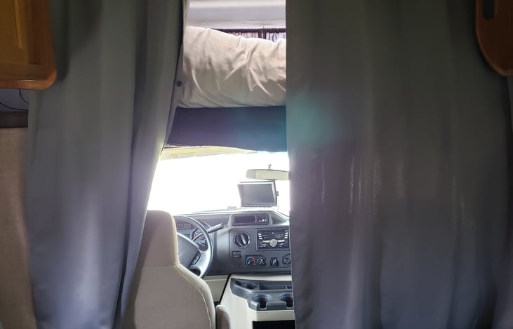 Privacy curtain for the upper bed and to block views from the front window.