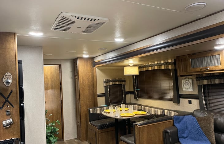 Dinette Area.    Cabinet includes colander, mixing bowls, variety of plastic food containers, extra bathroom towels, washrags, and hand towels. and RV biodegradable toilet paper.