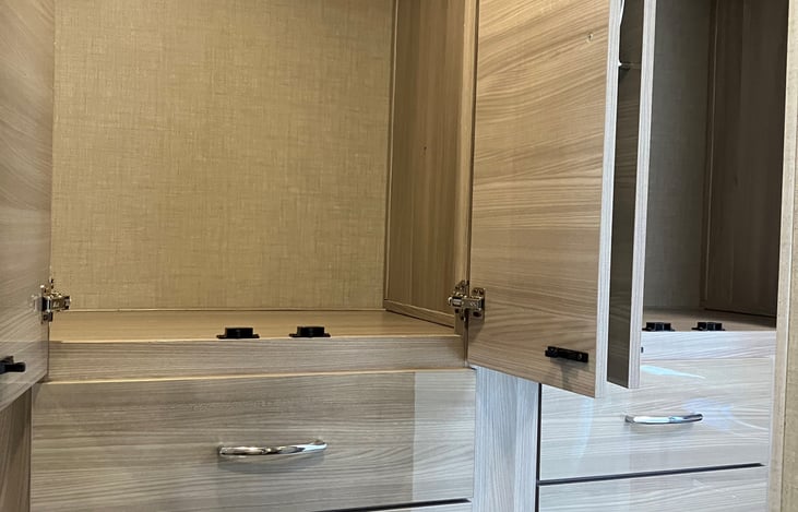 Double closets with drawers below.