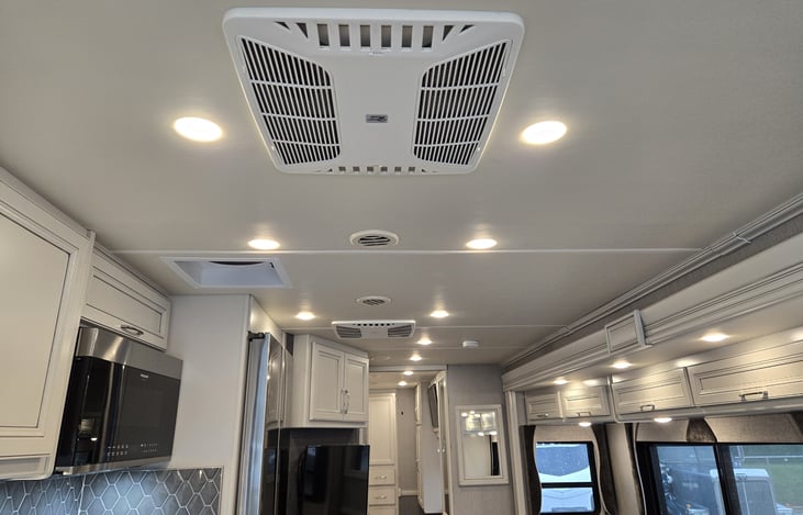 View of ceiling lighting and front / rear air conditioner feed sources with duct feeds as well.