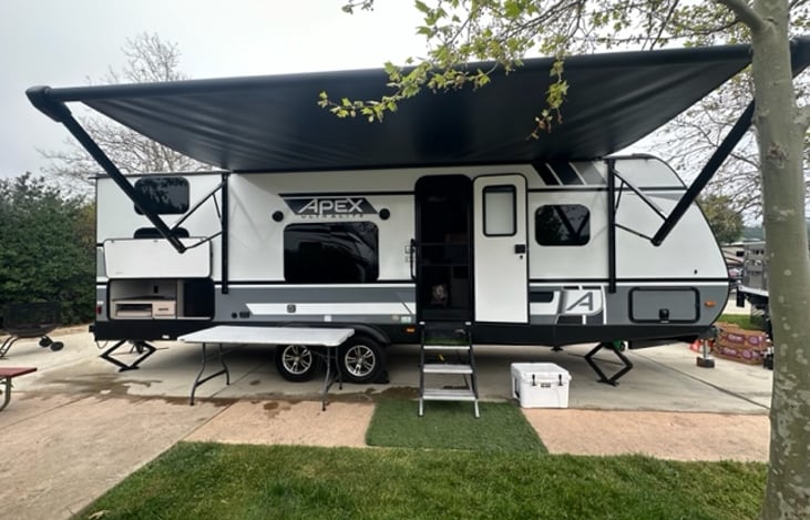 Side entry door view with awning and outdoor kitchen open