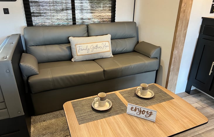 Lower dinette table into a coffee table and place it in front of the comfy sofa for some tea of coffee!