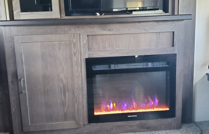 Electric fire place is also a heater. You can program heat level, timer up to 8 hours and different colors. Keeps camper warm all night.
