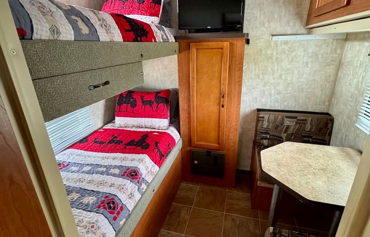 Back bedroom bunk area. Roku TV and DVD player located in the storage cabinet.