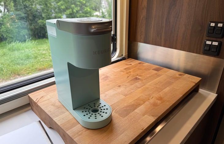 cutting board over stovetop for extra counter space & single-serve keurig