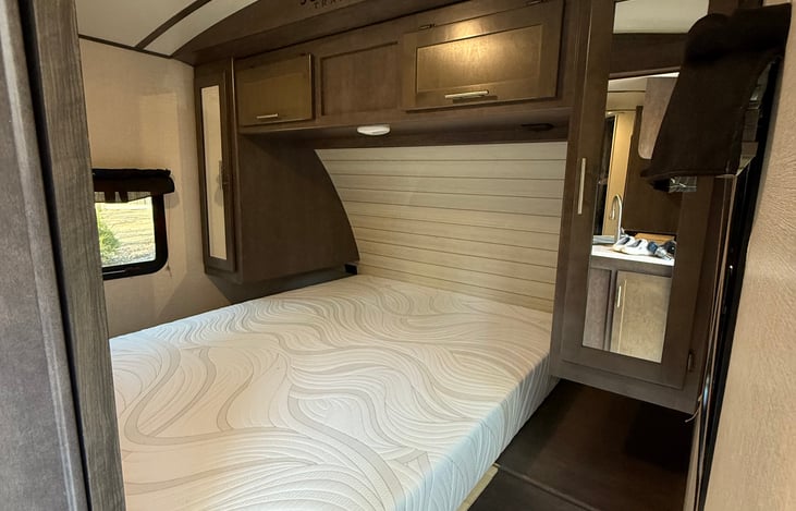 Bedroom with queen bed, TV and lots of storage