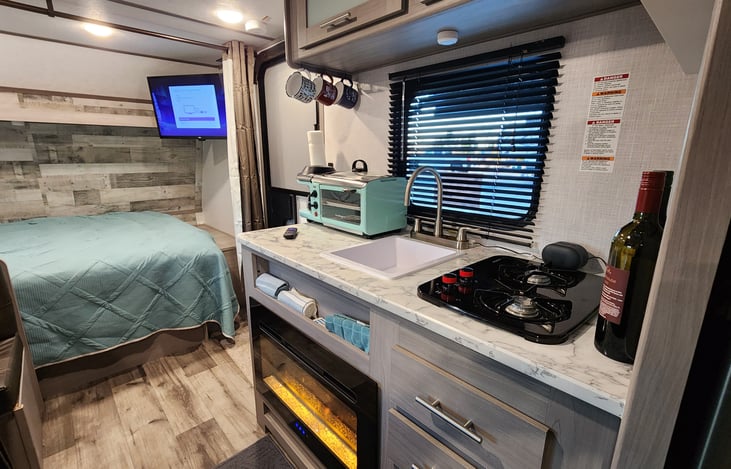 Ruby includes Queen Bed with linens, 32" Smart TV, Pots/Pans, dishes and utensils and most common kitchen gadgets. Toaster oven with coffee maker combo.