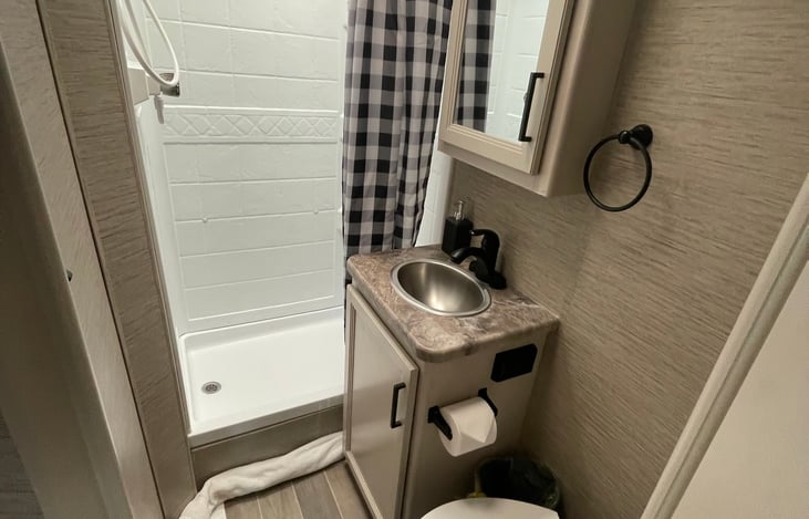 Shower, sink, toilet, toilet paper, towels and hand soap provided