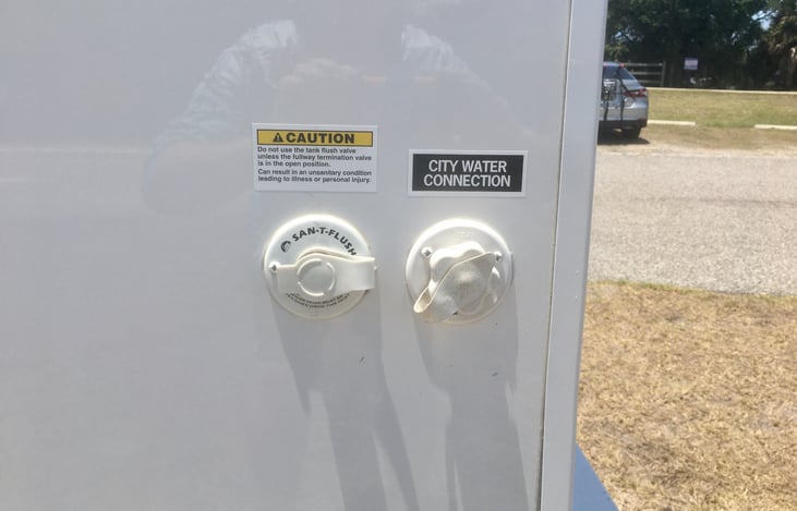 City water (potable/ drinking) connection for supplying “in house” water supply for showering, cooking and cleaning

Sani Flush connection for water clean out of black tank when at dump station