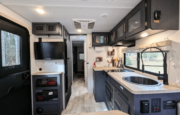 Cozy, modern and bright living area with well-equipped kitchen, TV, large dinette that converts to a bed, pop-out window and whimsical touches throughout.