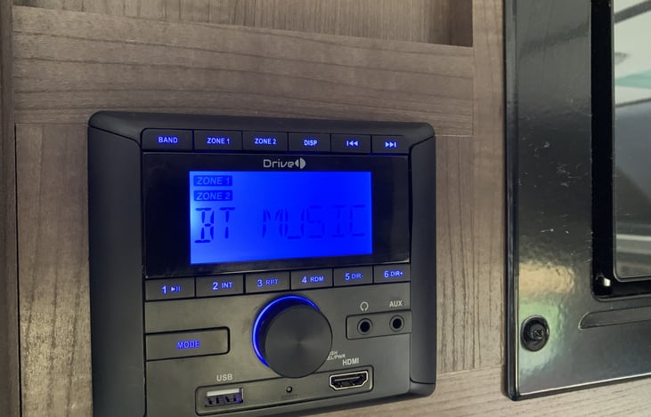 The BT radio, where you can play your favorite tunes inside or outside of the camper. You can choose the area where you want the music.