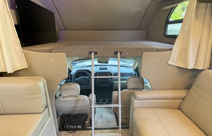 Over the cab bed. Easily sleeps two and has a privacy curtain.