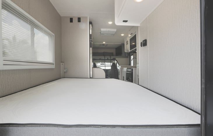 Main bed and living area in the back