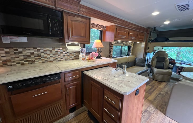 Kitchen hosts a double sink and lots of cooking space