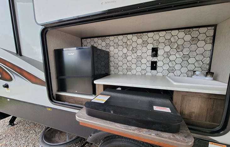 Outdoor Party Center with minifridge, gas burner, sink, and power outlets