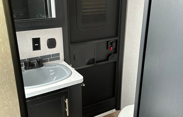 Inside view of the bathroom with plenty of leg room. Under sink storage and medicine cabinet storage behind the mirror. Separate entrance from outside.
