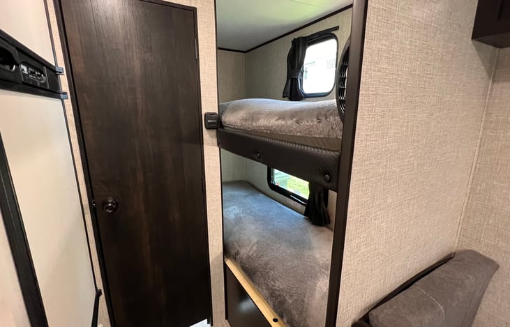 Both bunk beds equipped with memory foam mattress pad for added comfort. 150lb capacity per bed. (Door is bathroom entry).
