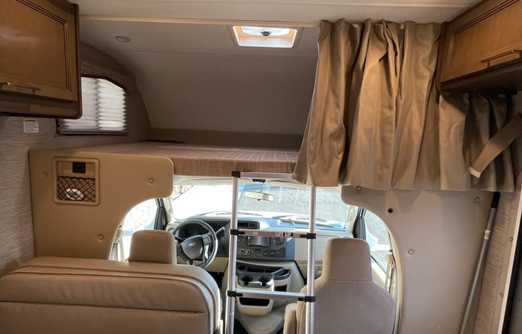 Upper bunk queen bed,  privacy curtain, and adjustable ladder. Can sleep two adults. Bedding can be added as an add-on, see add-ons list.