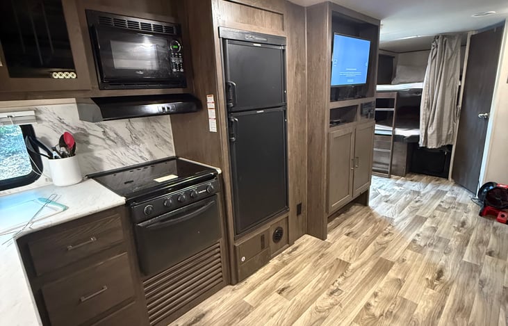 Great kitchen with all conveniences of home. Backsplash, farm style sink, appliances, charm.