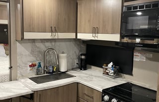 Kayaks, paddle boards, and camper.