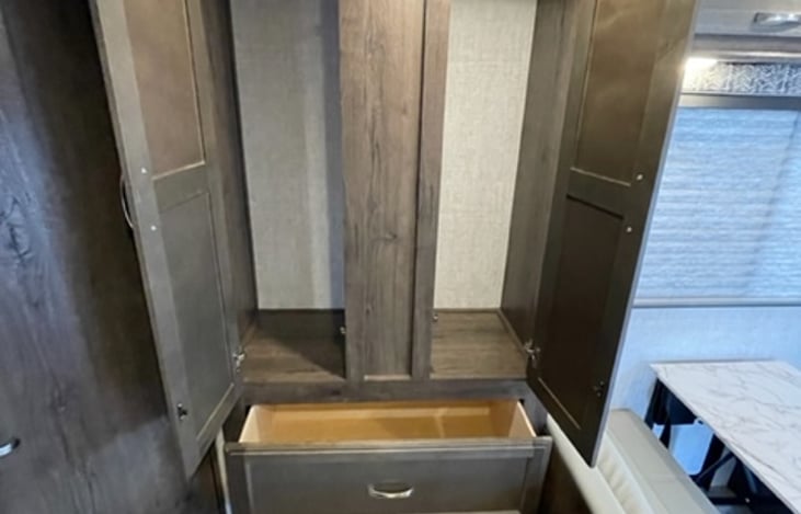 Armoire style closet storage open for you to see the set up.