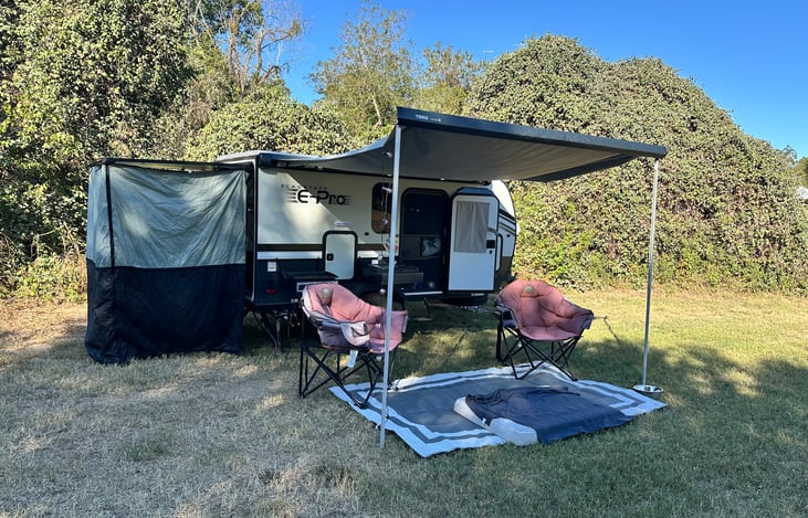 Full expanded camper. Curtain on back is privacy for an outdoor shower or to protect you from the elements when preparing food. Curtain is located in the front storage in the purple bag