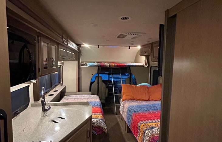 There are four beds to choose from, one above the cab, two in the kitchenette and an extended queen in the rear. All are equipped with foam mattress covers if you choose to use them.