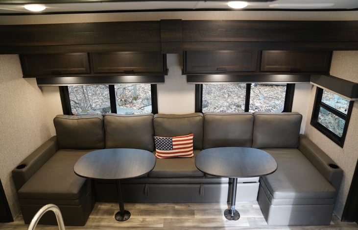 Huge living room couch with tables installed.