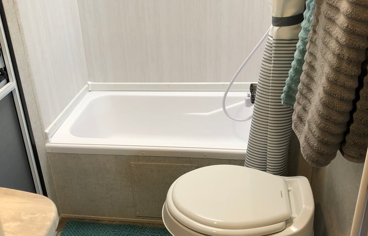 Bathroom shower, toilet, sink and outside door