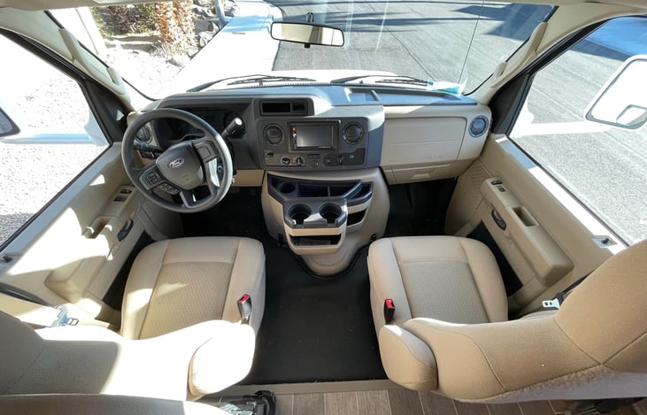 Touch screen blue tooth radio, backup camera, in-dash air conditioning, and USB Port. Three-compartment cup holder, cruise control, power steering, power windows, and locks.