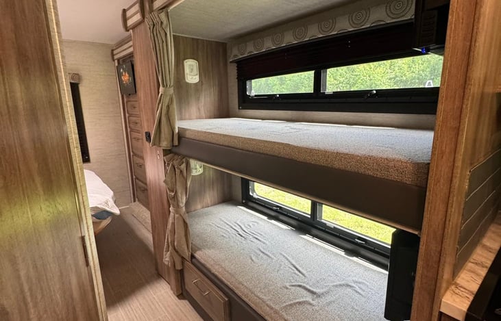 Each bunk bed has its light and a curtain for privacy!