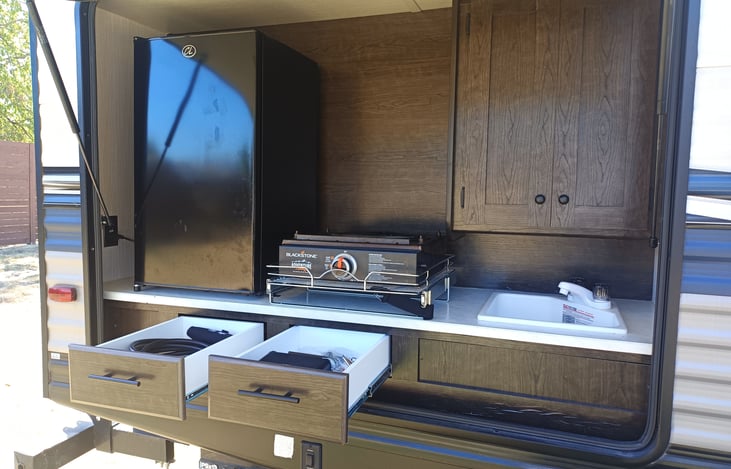 Showing 2 drawers for storage ... Where the griddle gas hoses are stored as well as S'mores tools