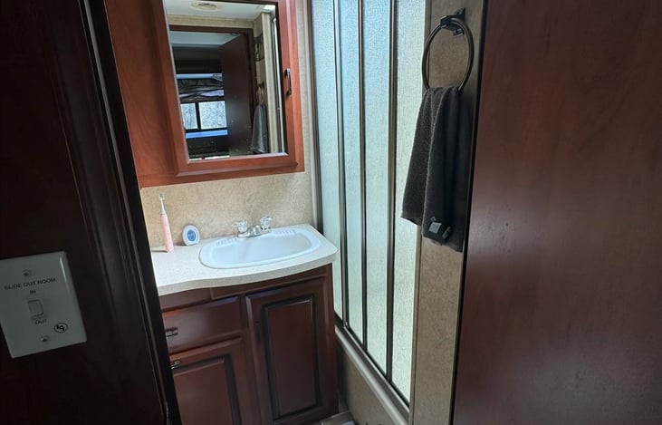 Stand up shower, sink, and toilet.