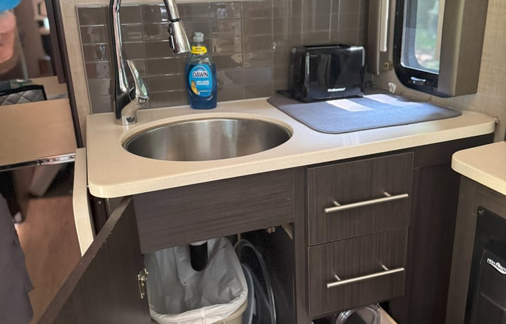 Kitchen sink work area with side drop down table