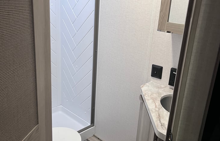 Bathroom with shower, sink and toilet.