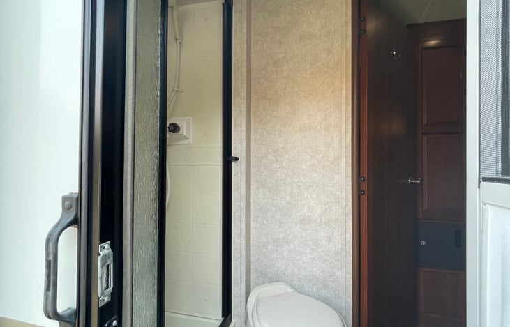 Bathroom with shower, doorway leading in/out exterior and interior