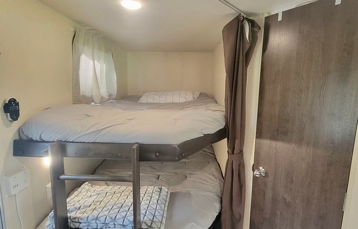 Bunk bed with full size mattress on each! Bottom bunk folds up to store anything from bicycles or bins.
