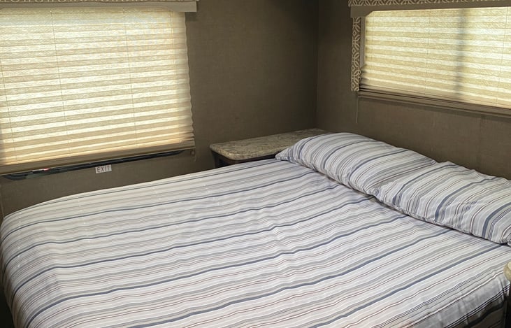 Master Bedroom with two windows. Access below to storage