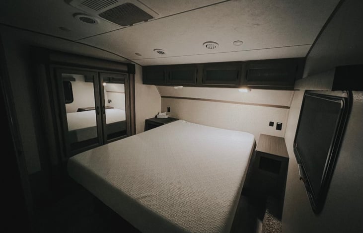 Master bedroom with individual A/C, residential queen bed and plenty storage with 3 closets, cabinets above the bed, nightstands and even more storage the lifting up the bed.