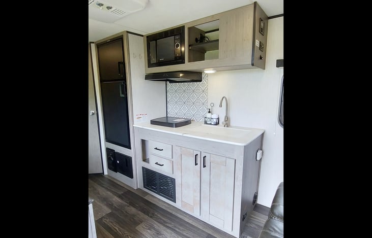 Kitchen: LG sink, cutting board, double burner stove, microwave, pantry shelves, TV/Cable Hook up, stereo system, 4-plug electrical outlet, wall key hooks (2).