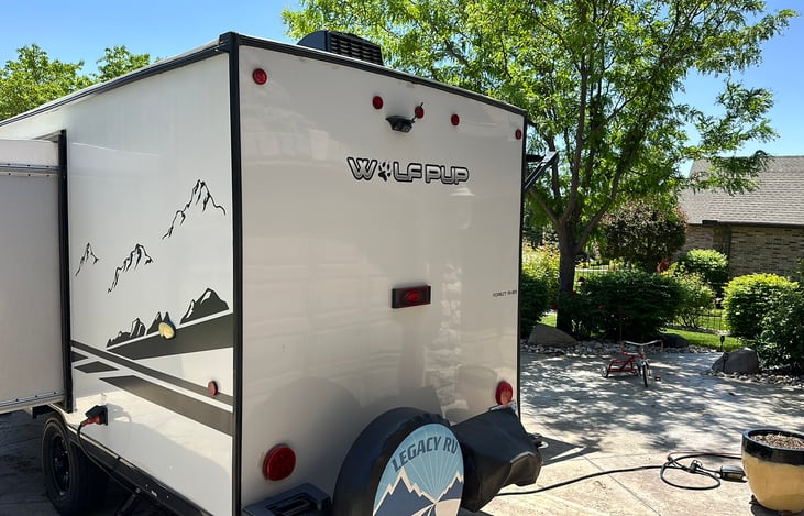 next to the spare tire is the swing away propane powered outdoor grill.