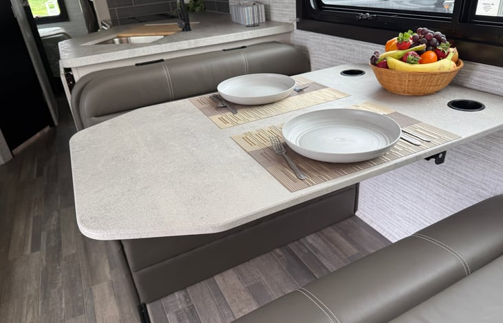 Table with cup holders to prevent spills.