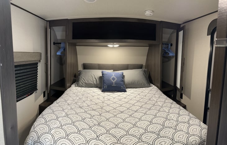 Queen bed master bedroom with storage doors open. All beds are made and have waterproof, bedbug proof and dust proof covers on all pillows and mattresses. 4 pillows on this bed.