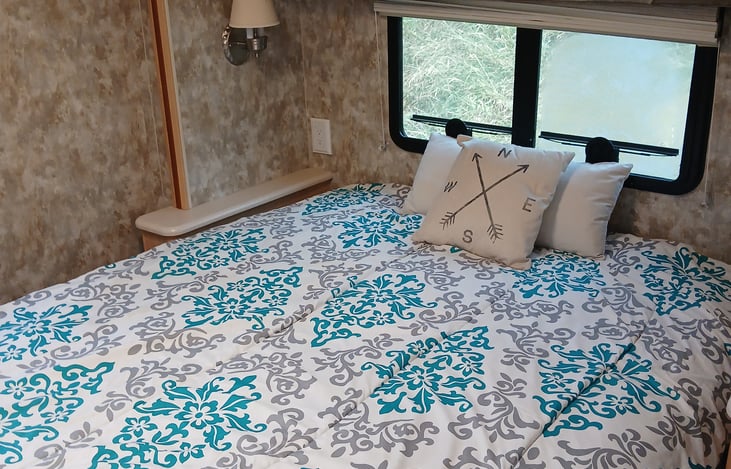 Rear queen bed with pillowtop mattress cover provided!