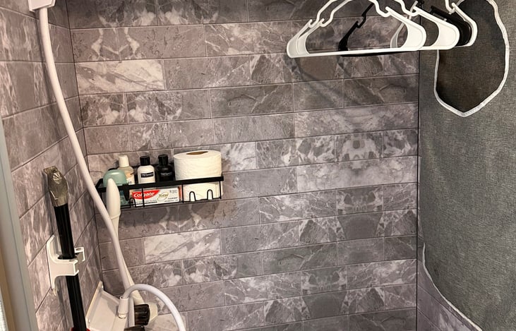 The wet/ toilet is nice and when not in use, a clothes rod is handy for hanging up your clothes.