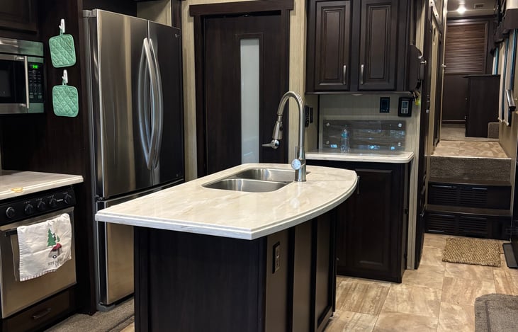 Great functional kitchen, fully stocked with utensils, pots, pans, bakeware, bowls, plates, cups, and silverware.